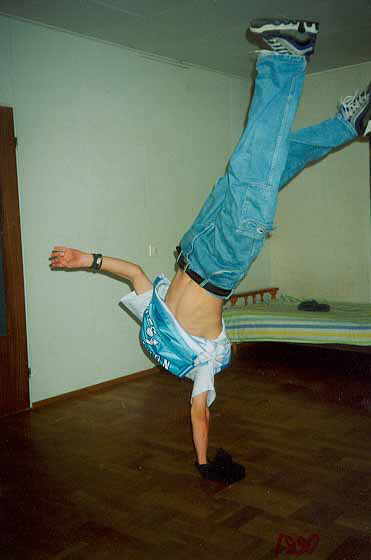 Performer executing '1990,' b-boy goes into a handstand and spins as much as possible
