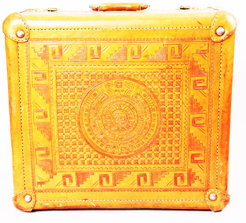 A Mayan inspired leather suitcase.