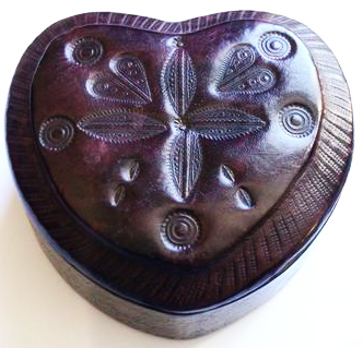 Leather box with an intricate design demonstrating symmetry.